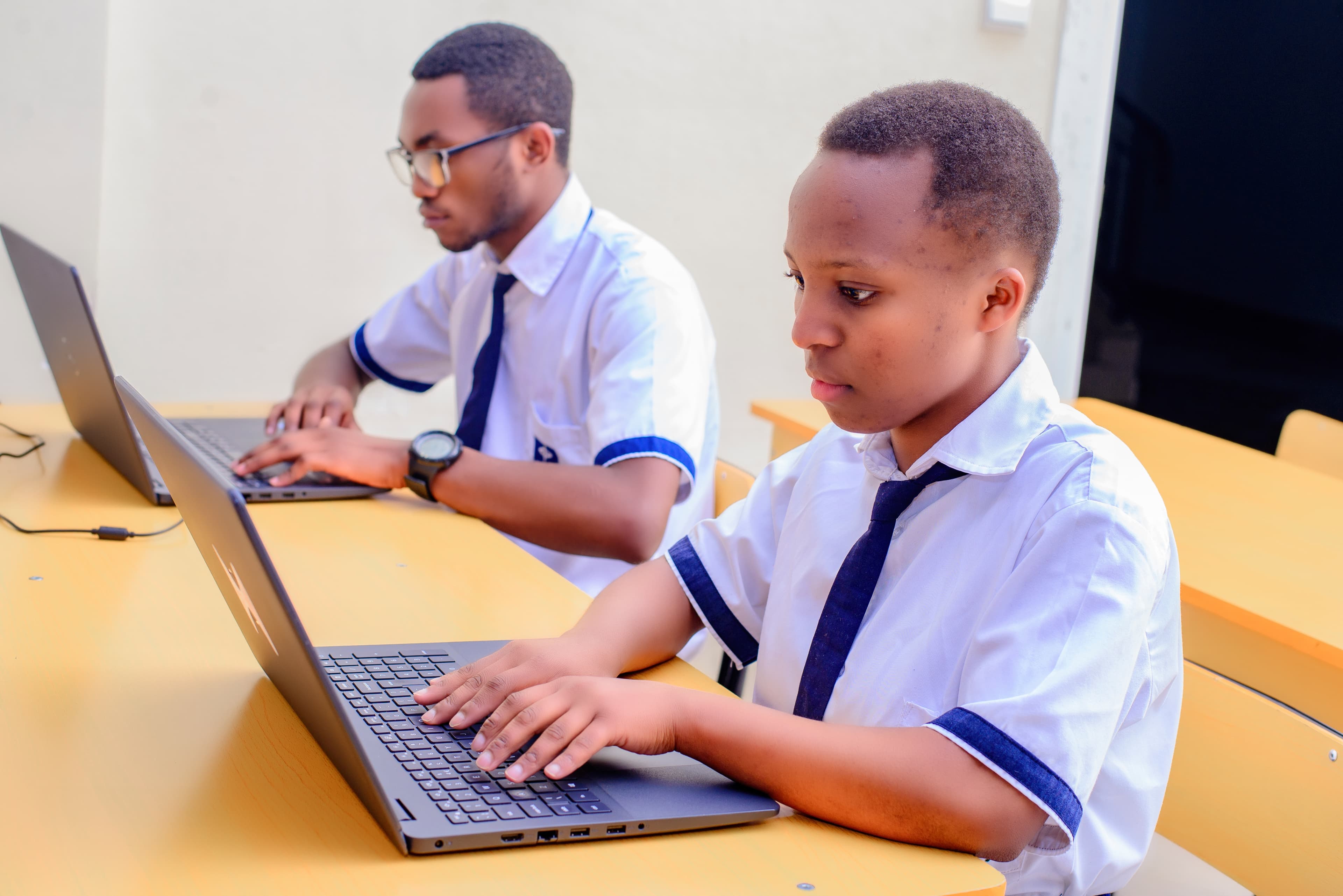 Uwera students learning with laptops
